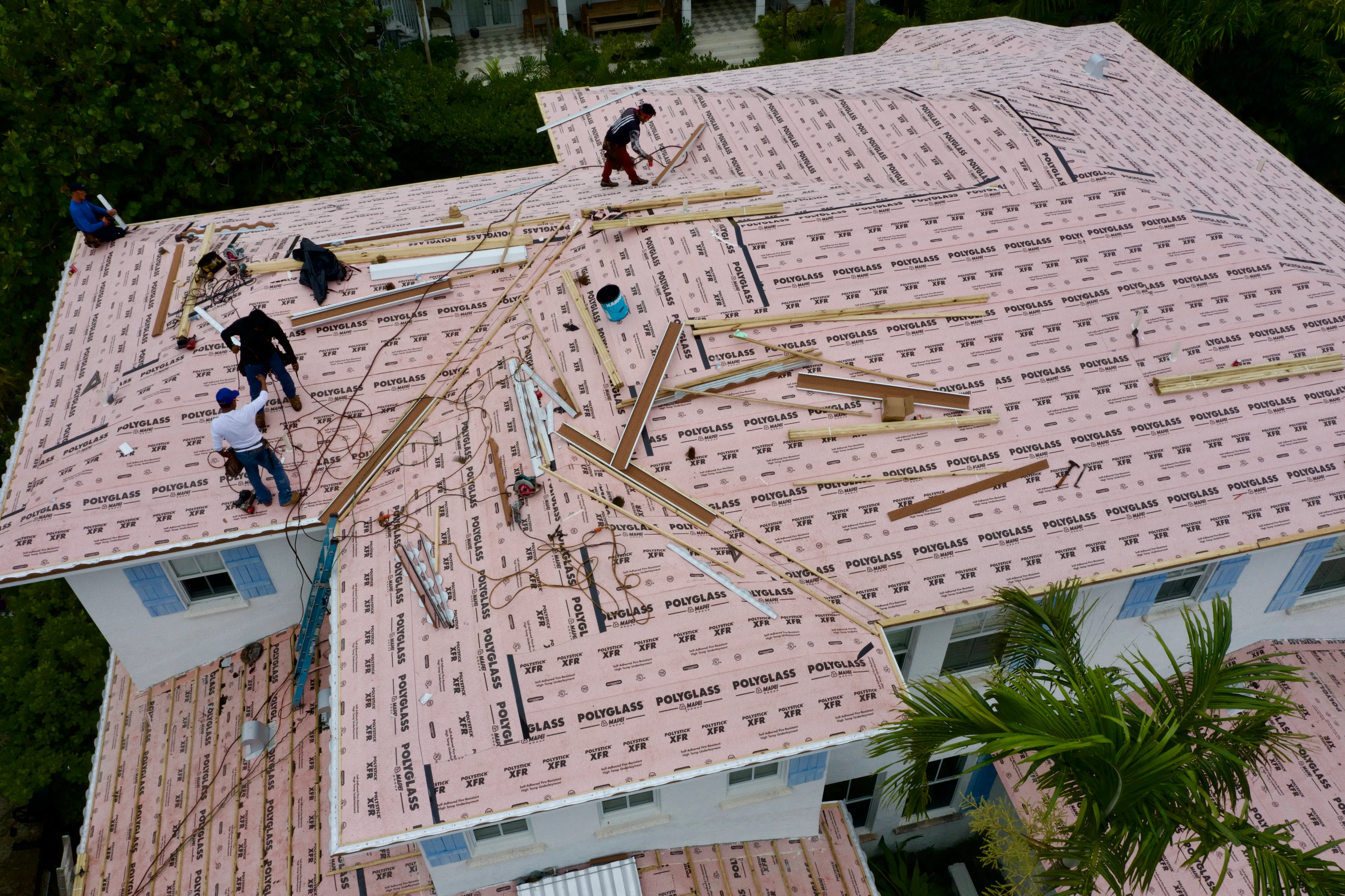 Crew installing fire-resistant underlayment on a South Florida roof.