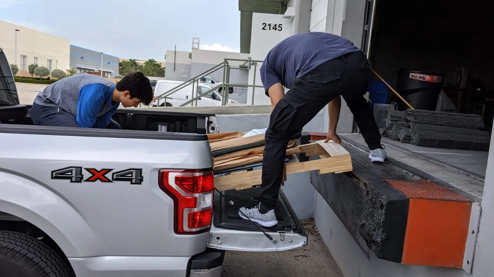 A roofer loading materials onto a truck.